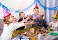 Joyous boys and girls happy to celebrate friendÃ¢â¬â¢s birthday Royalty Free Stock Photo